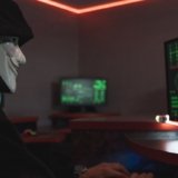 A Person With Mask Using A Computer